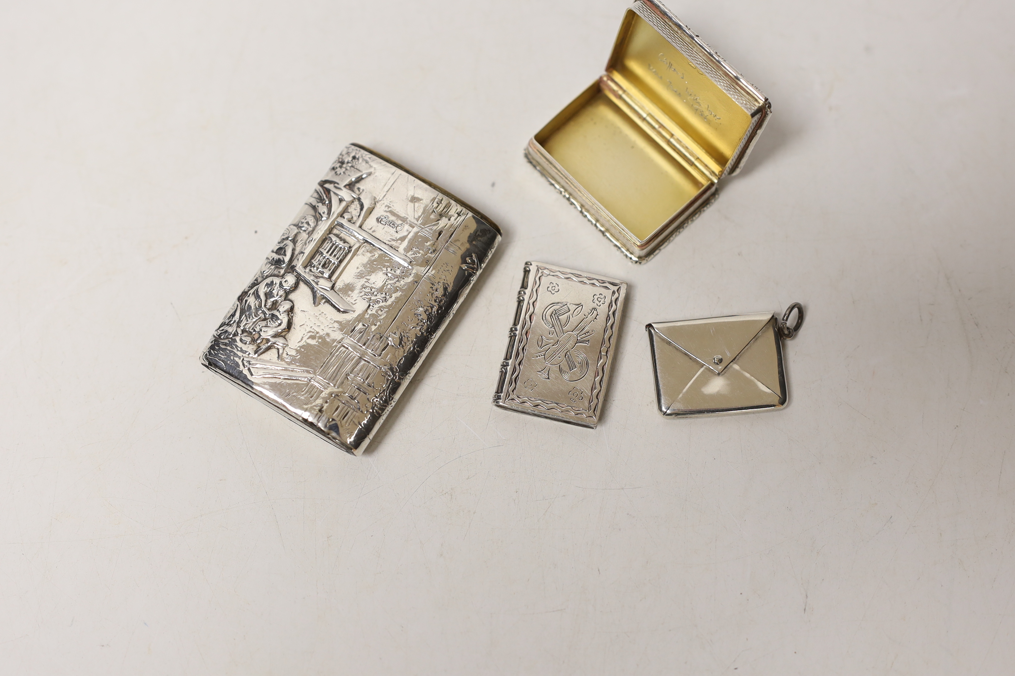 A modern silver snuff box, an Edwardian silver 'envelope' stamp case, a German 925 snuff box and an unusual antique white metal spinning fob seal case?